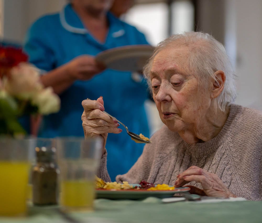 Care home resident eating apetito food